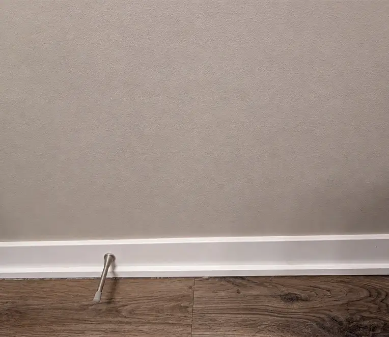Repaired drywall wall with smooth finish and blended paint after patching